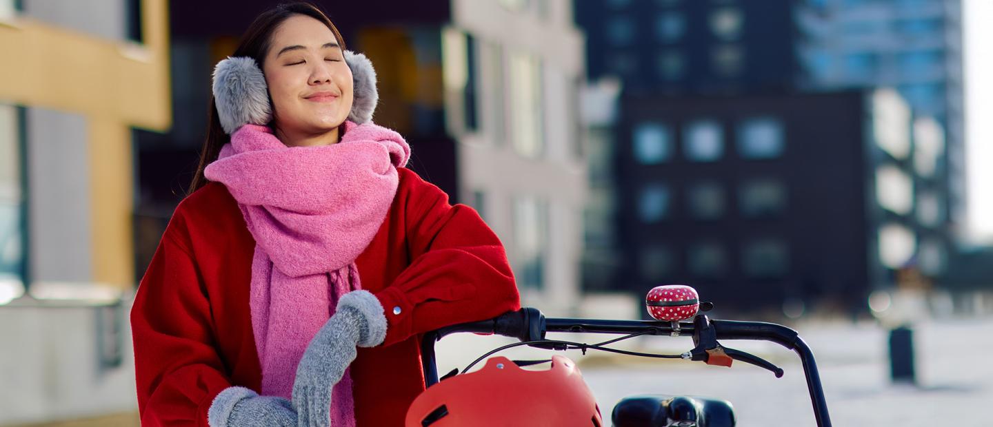 A young woman smiling with her eyes closed