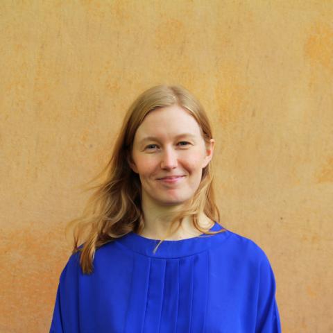 A white woman with long hair smiling at the camera