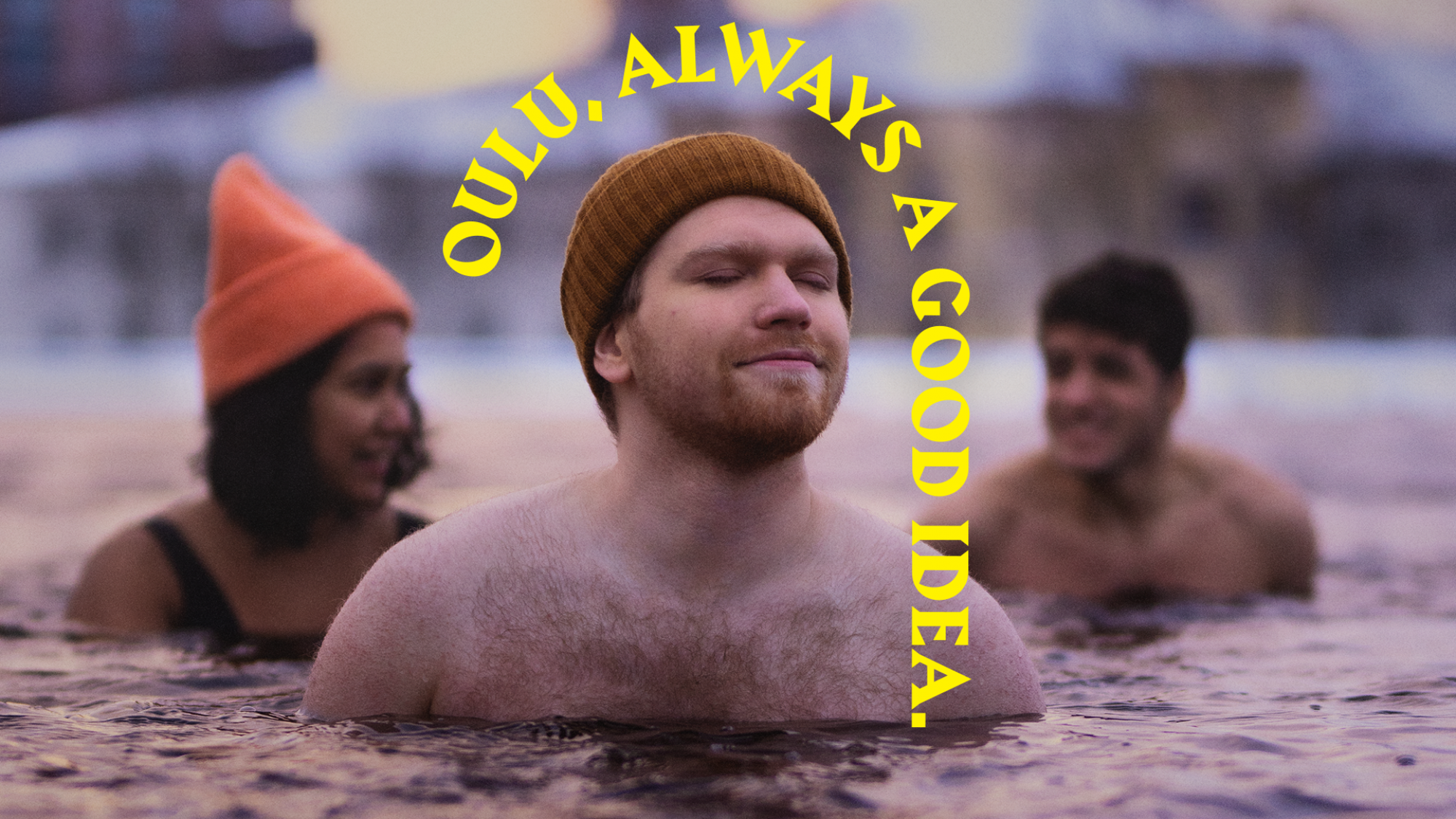Three students are swimming in an ice hole. In front, a man wearing a beanie has his eyes closed and is thinking. Behind him are a dark-haired woman and a man talking with each other. The man with the beanie has an arch appearing in top of his head stating "Oulu, always a good idea."