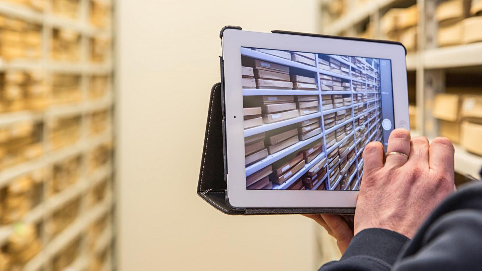 Product management, screening the items in the storage with a tablet.