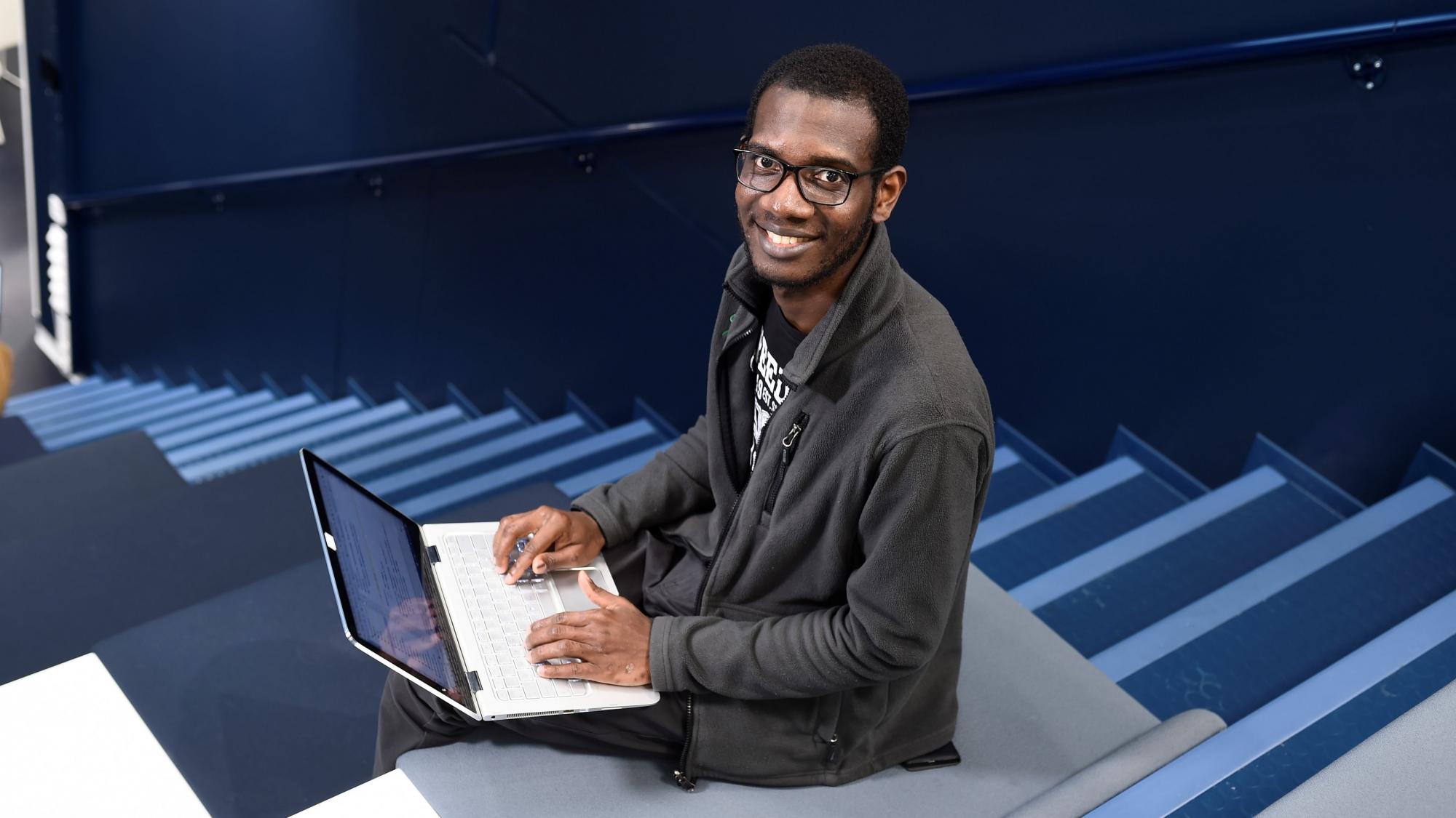 Software Engineering and Information Systems student in a lecture hall.