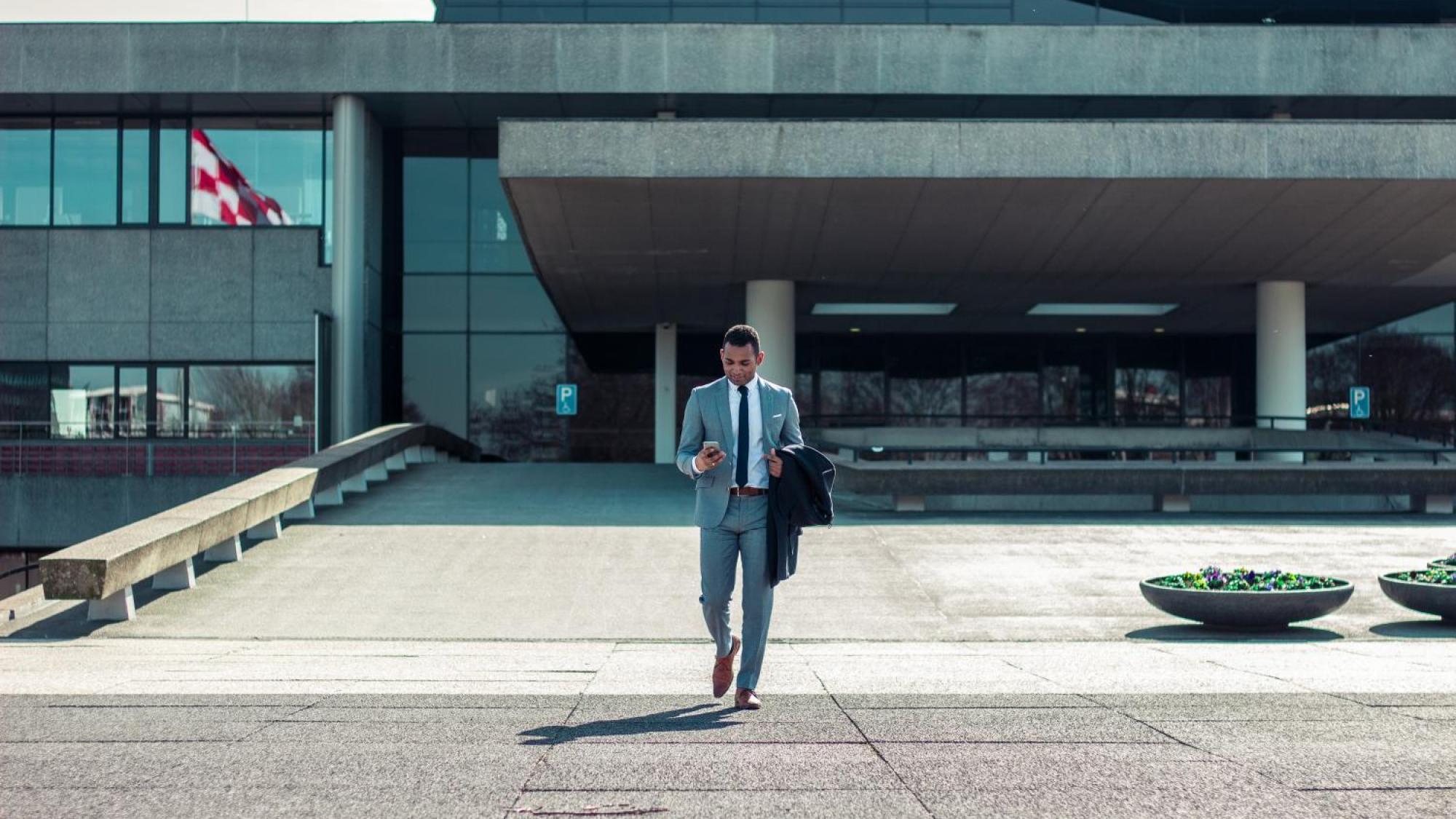 Man in business attire outside a building