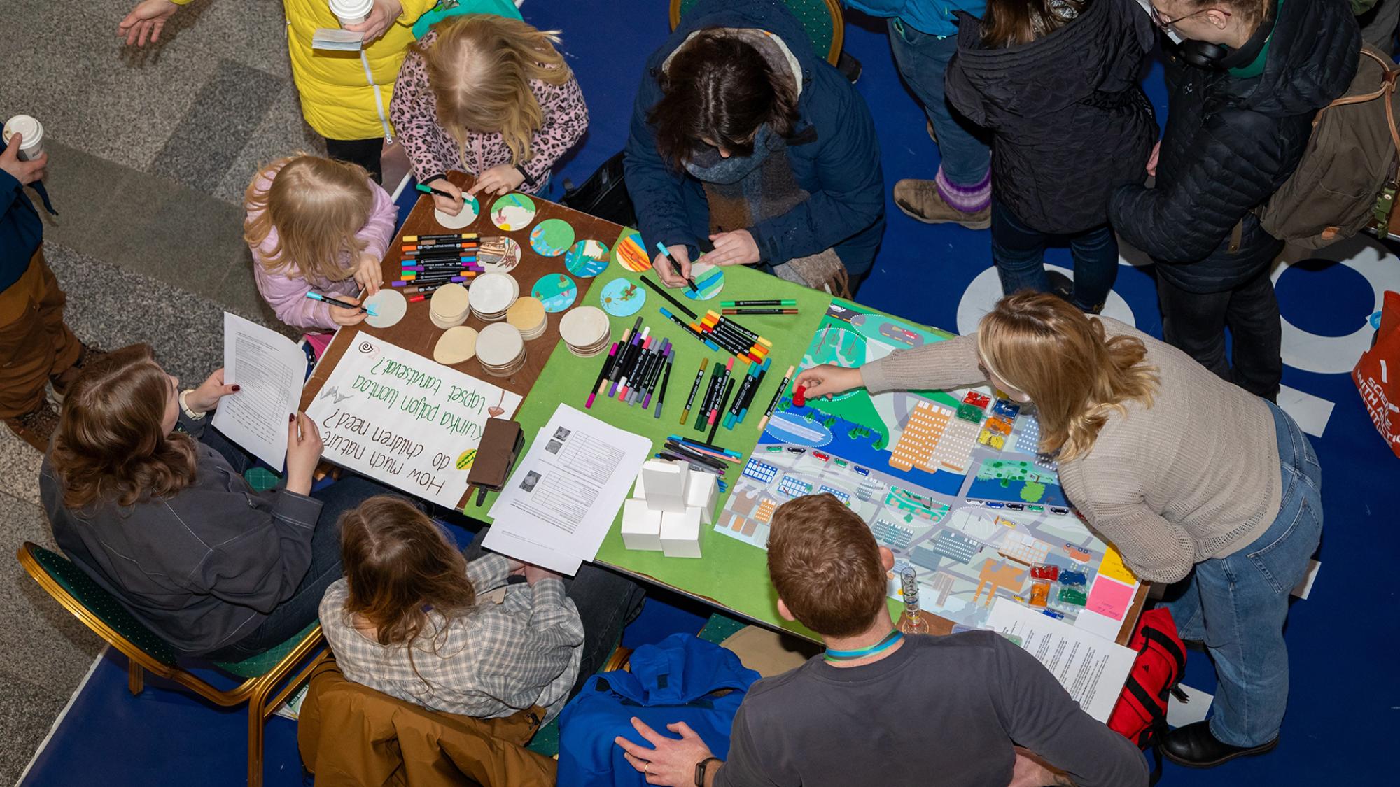 people working and doing crafts at a table