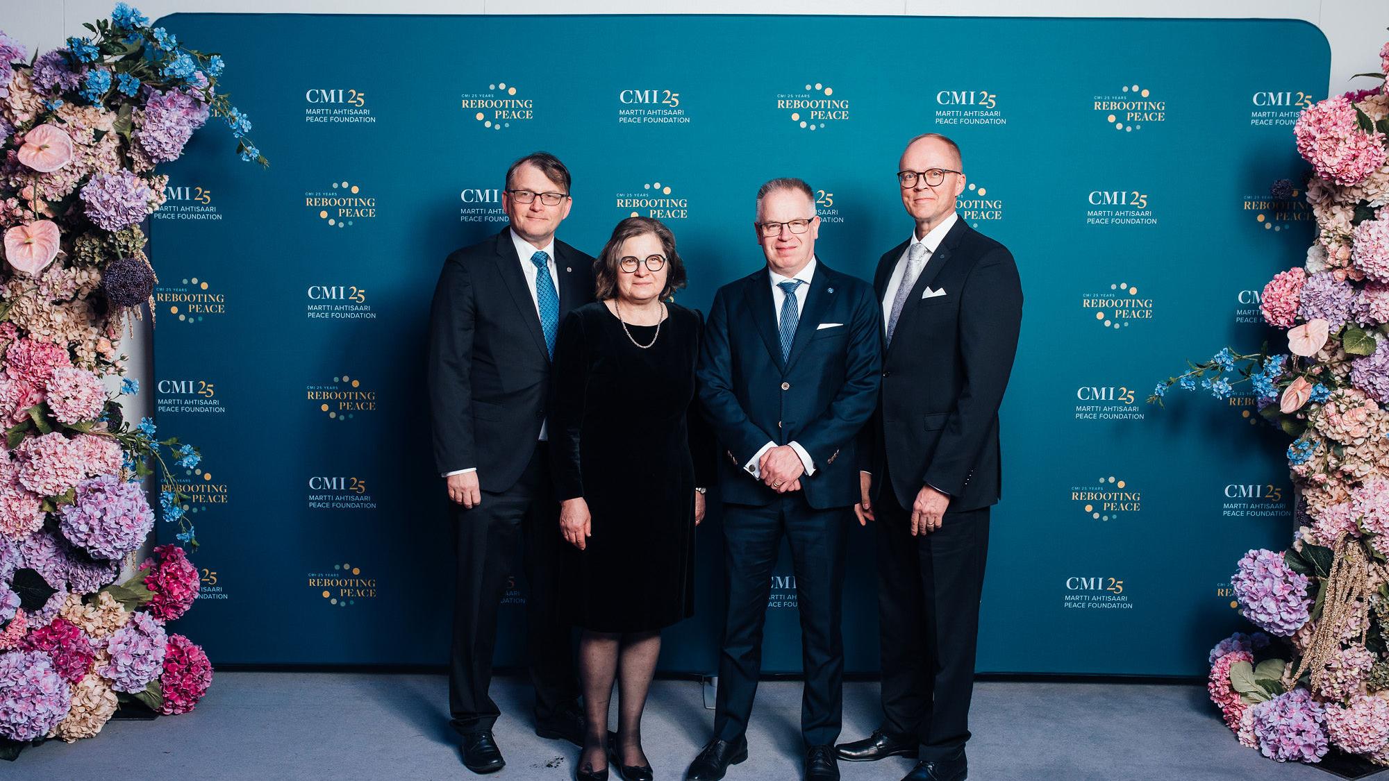 University of Oulu representatives standing in front of photo booth.