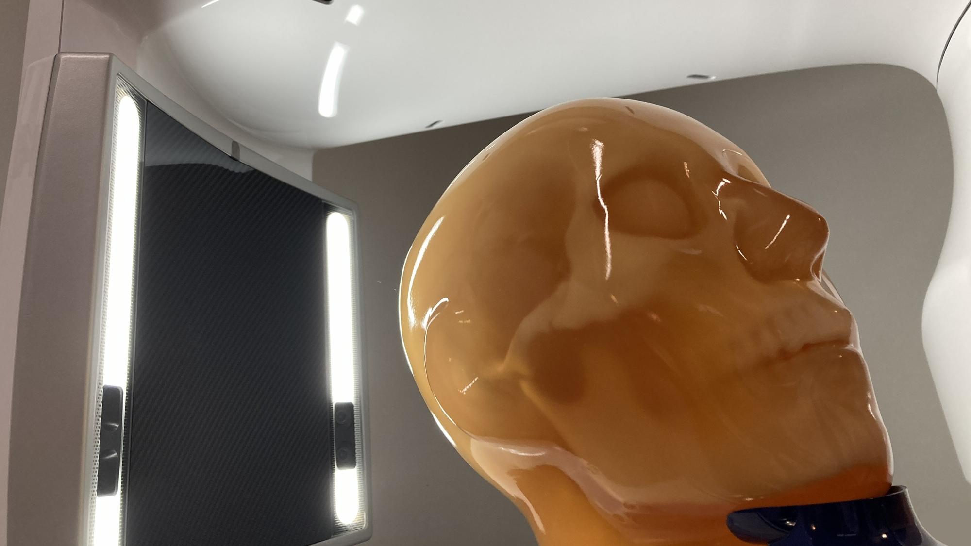Cone‑beam CT device scanning an anatomical phantom in a laboratory imaging setup.