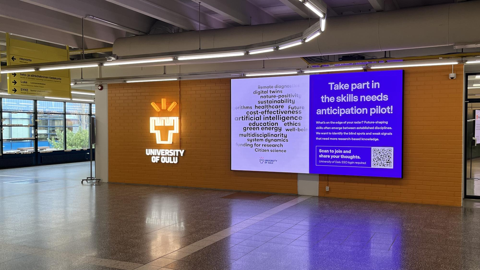 Campus screen in a lobby. A word cloud in the screen.