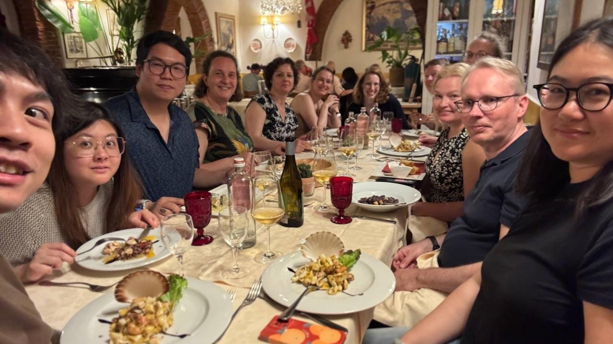 People sitting round a table at a restaurant and having dinner.
