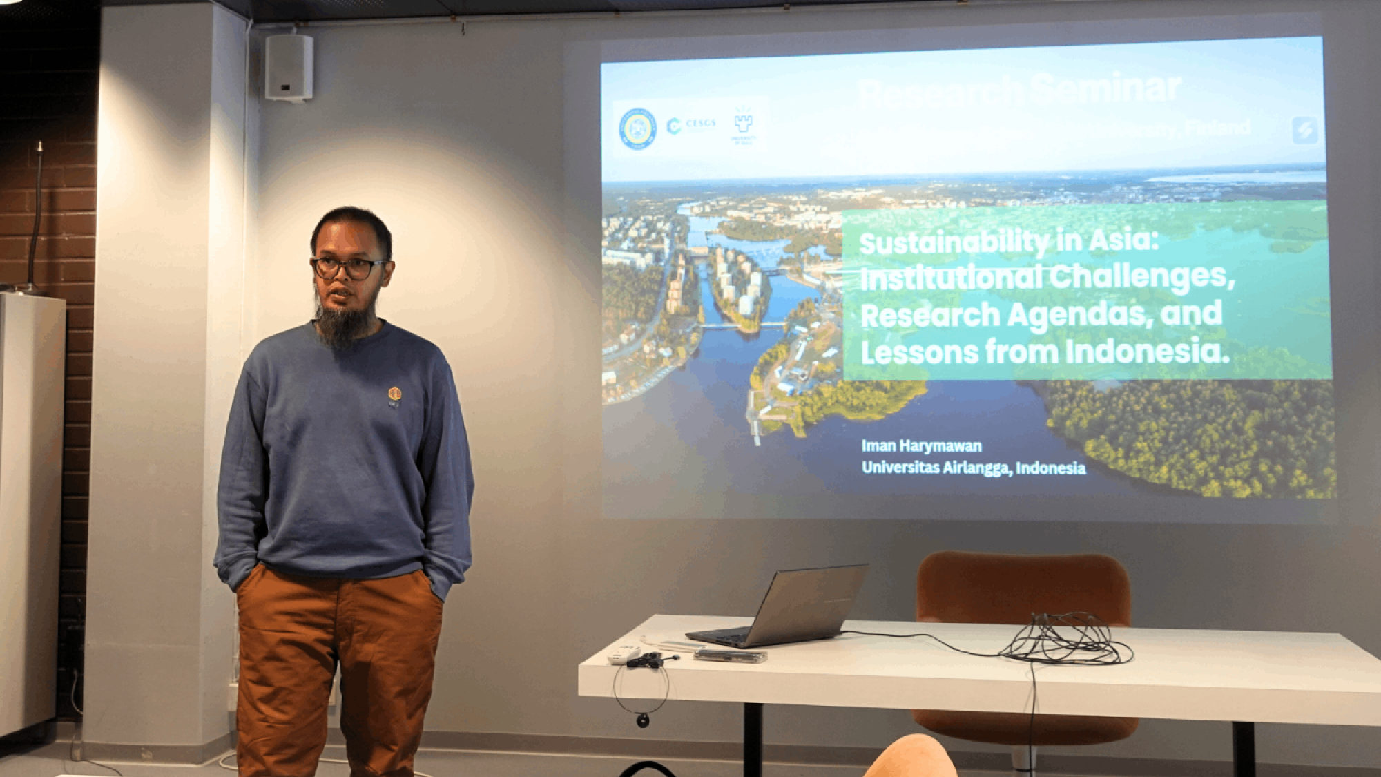 Professor Iman Harymawan speaking in a reserach seminar.