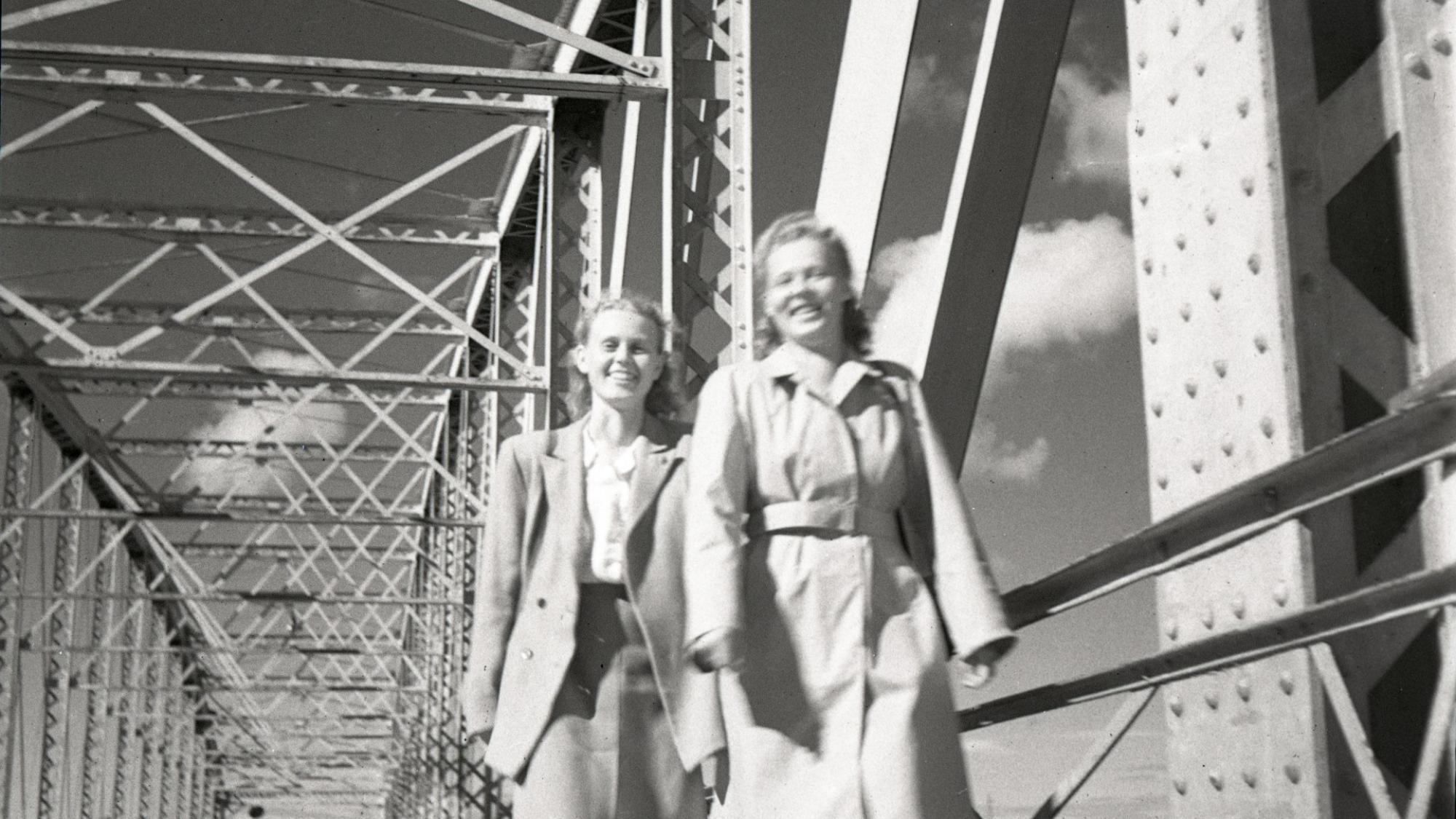 Kuva Oulun museon kokoelmista. Musta-valkoisessa kuvassa naisia kävelemässä sillalla