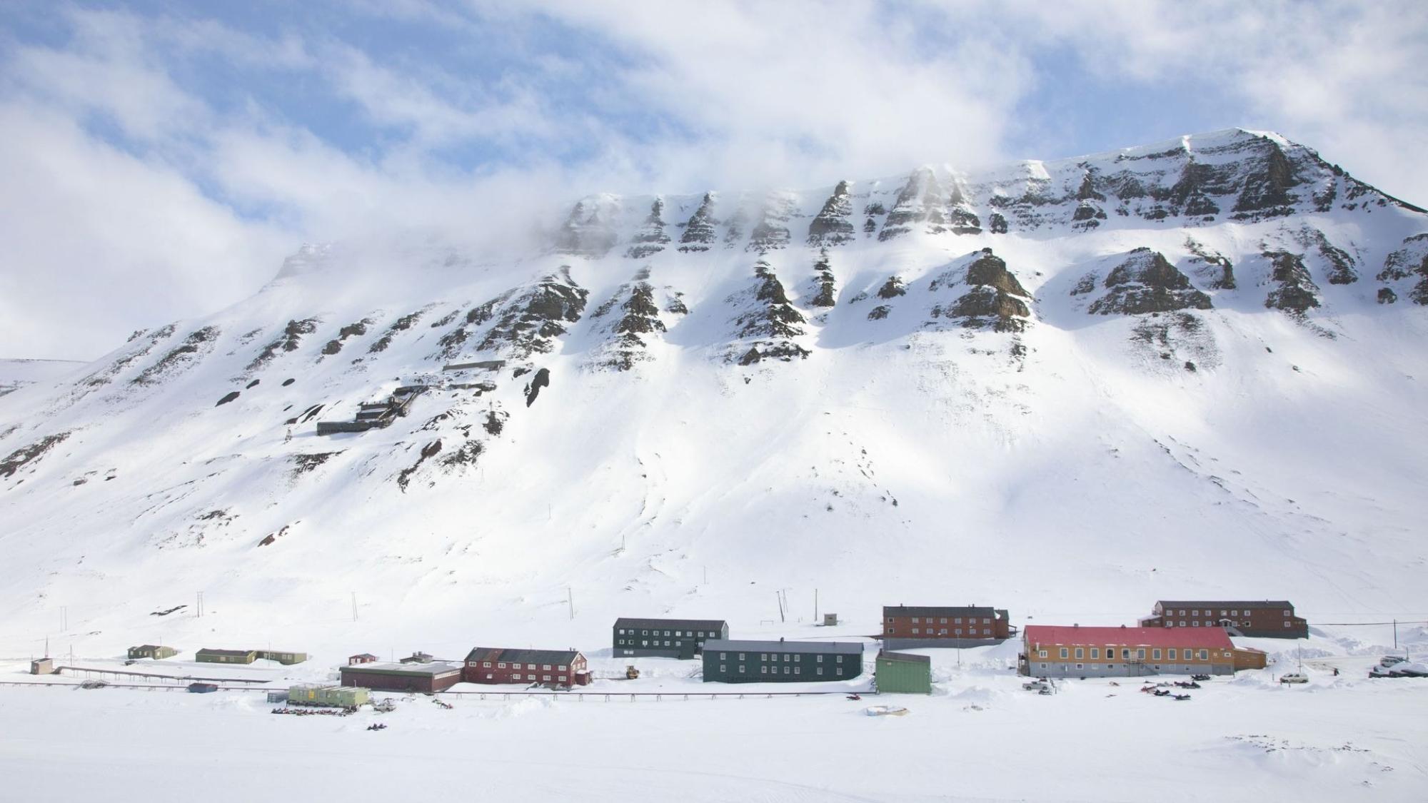Colorful houses in Arctic landscape with a mountain in the background, Svalbard