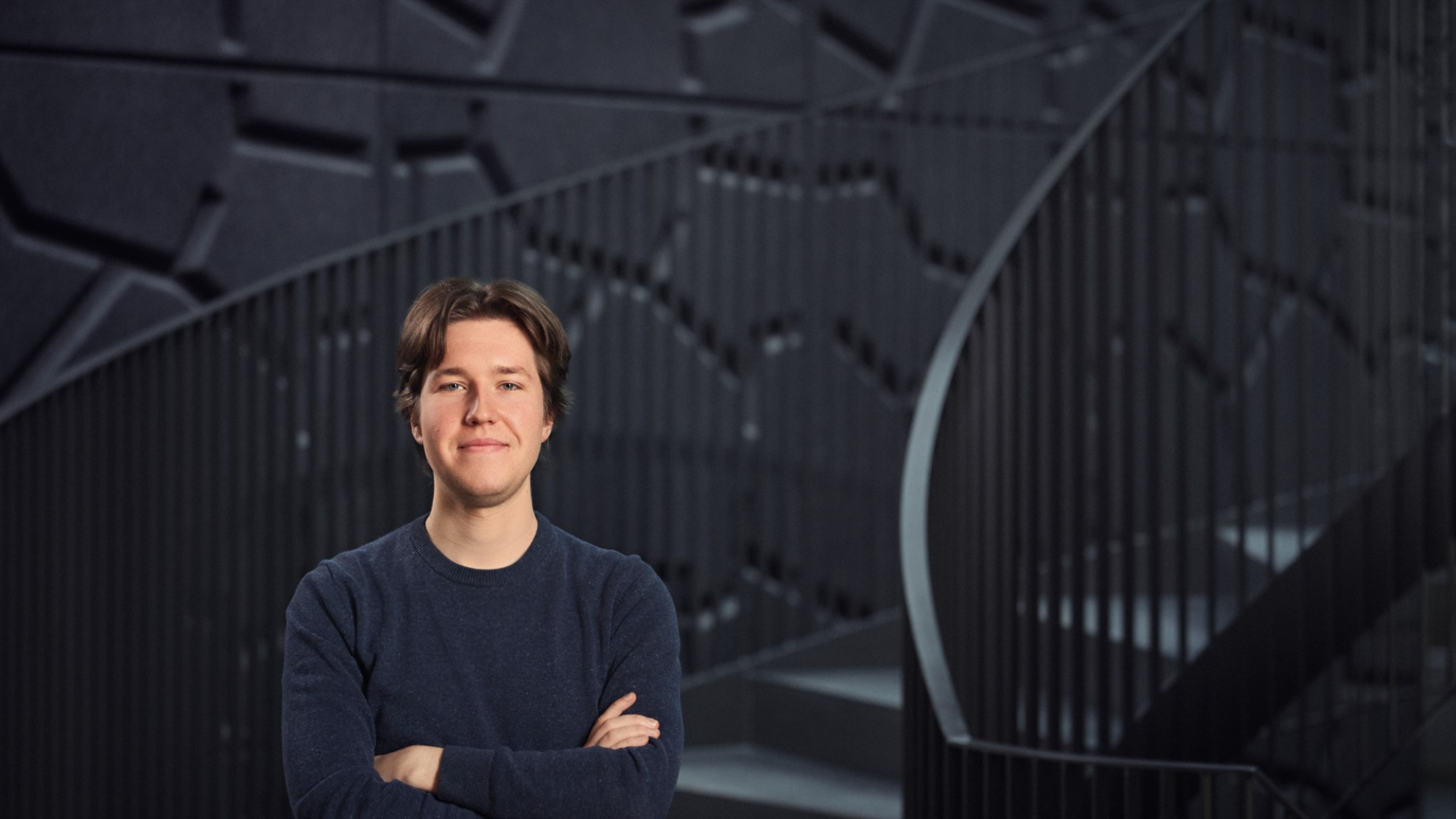 Joshua Schaaf standing with his arms folded at the Kieppi staircase in Kontinkangas