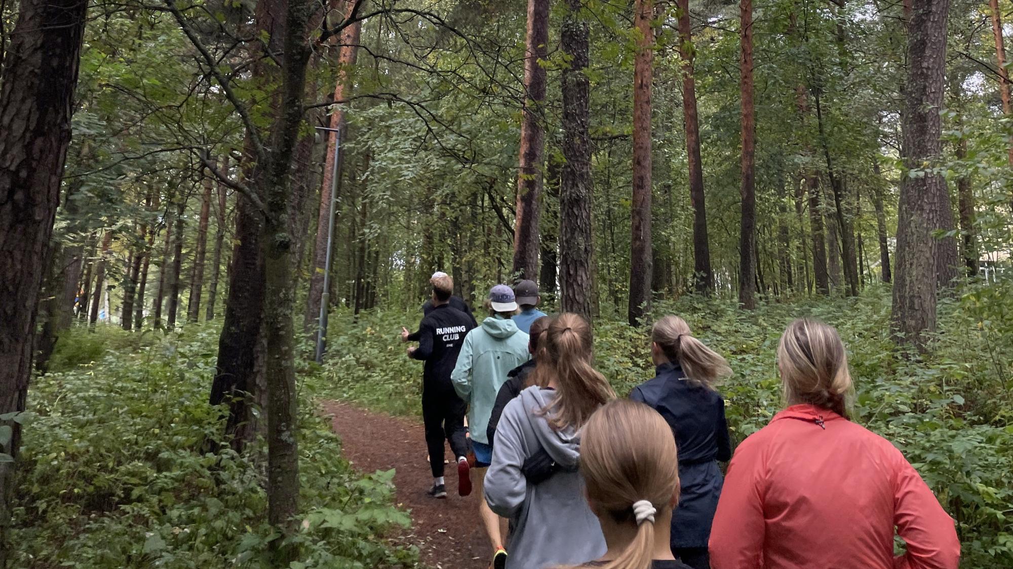 Students running in the forest