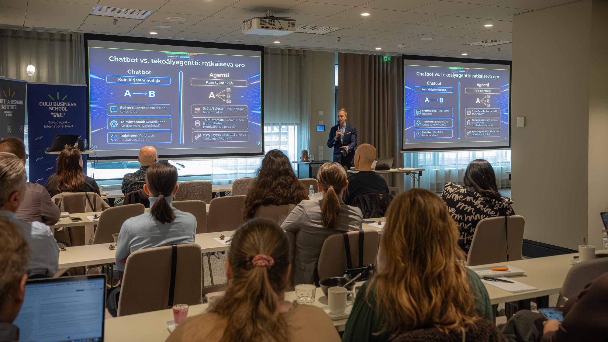 Valtteri Kujala speaking in front of a crowd.