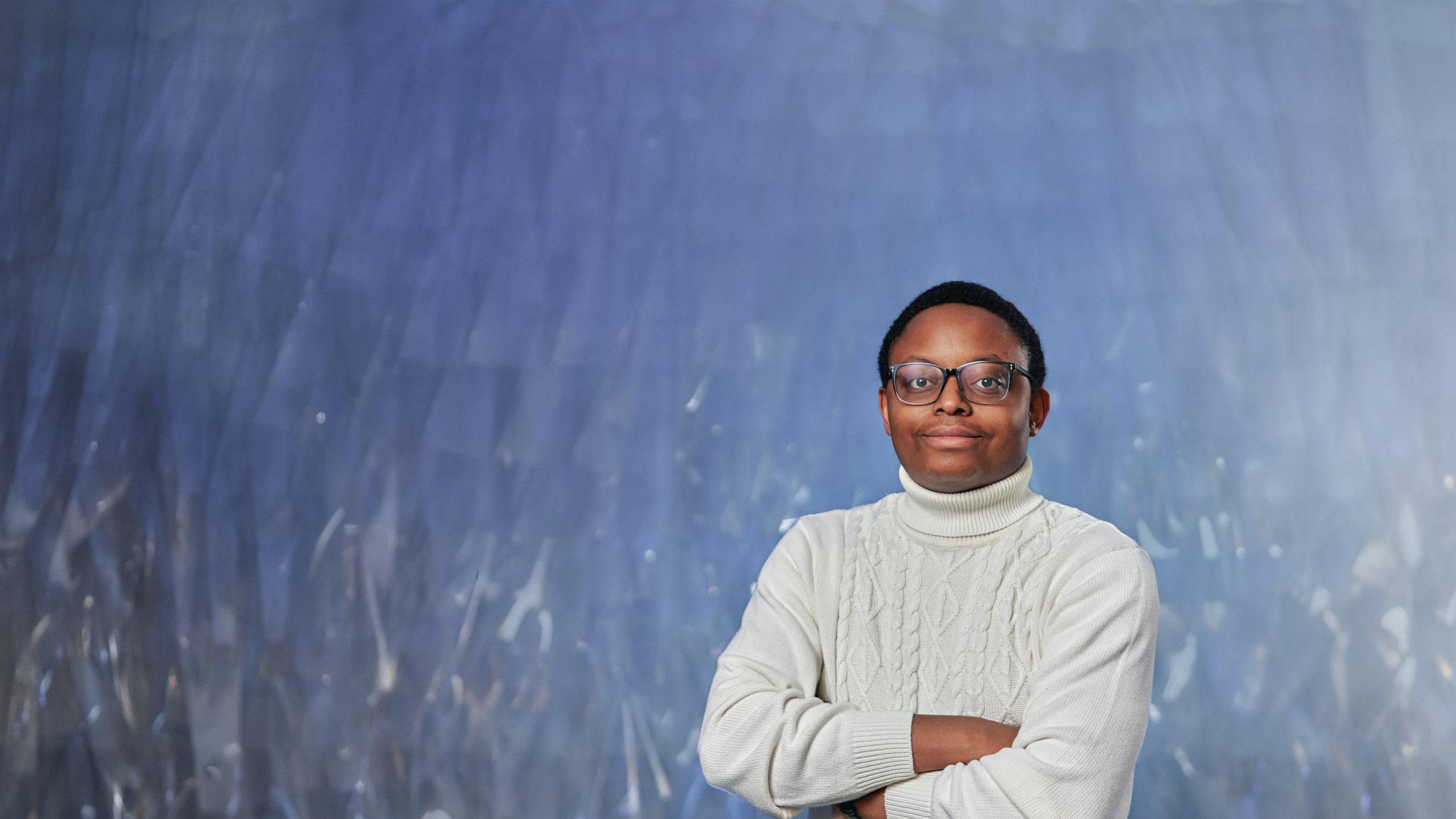 Chubo Zeko posing in a white polo-neck shirt